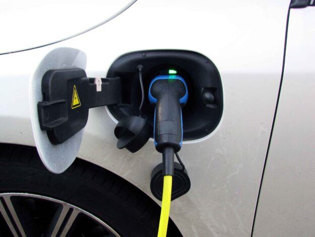 Image of EV car plugged into electrical port