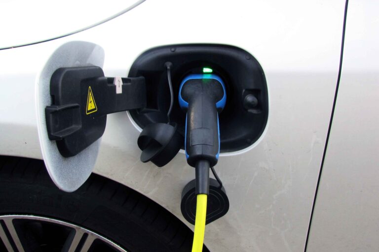 Image of EV car plugged into electrical port